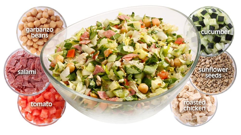 Chop Stop Classic Salad with garbanzo beans, salami, tomato, cucumber, sunflower seeds, and roasted chicken” title=